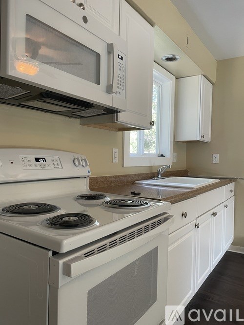 A white stove and microwave in a kitchen.