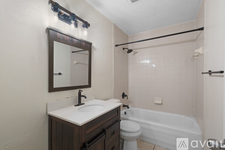 A room with wooden flooring and a window.