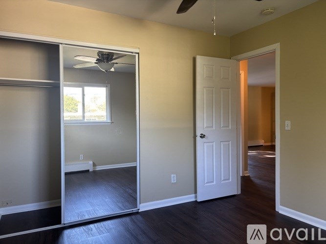A room with a sliding door and a ceiling fan.