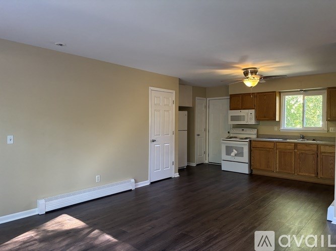 A living room with a white door and a window.