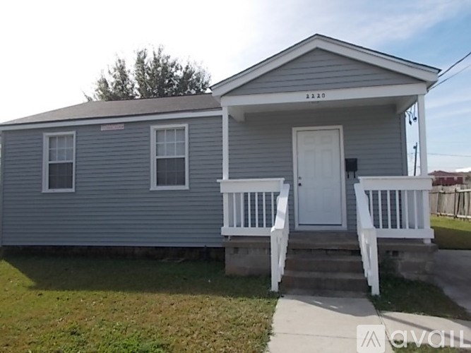 A small house with a porch and a white door.