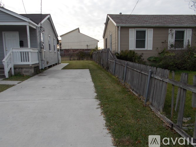 A residential area with houses and a fence.