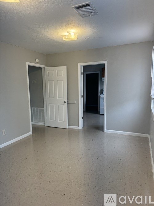 A room with two doors and a window.