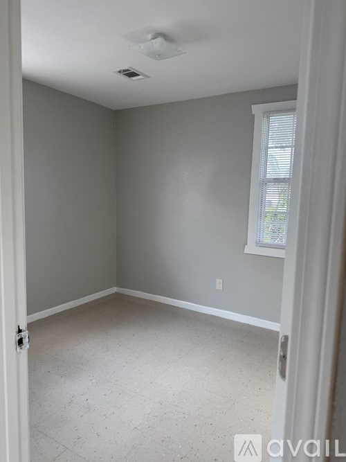 A room with a window and a door.