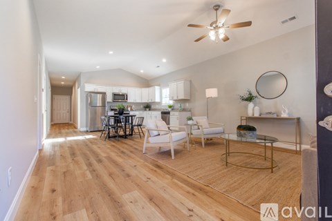 A spacious living room with a dining table and chairs.