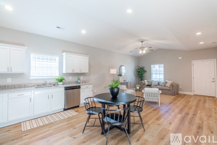A kitchen with a table and chairs in the middle of the room.