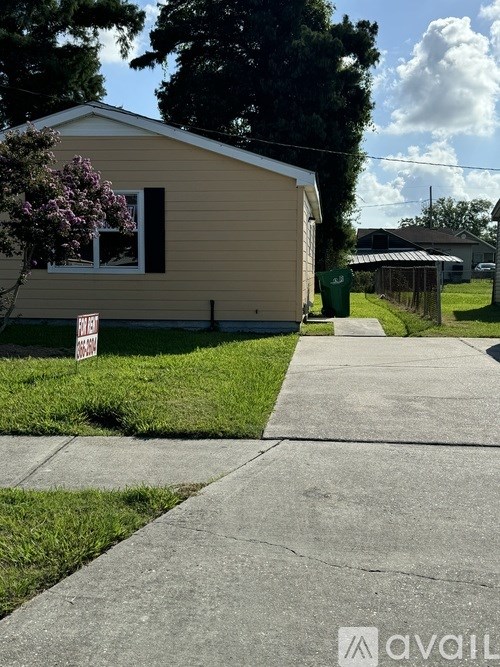 A house with a sign in front of it.