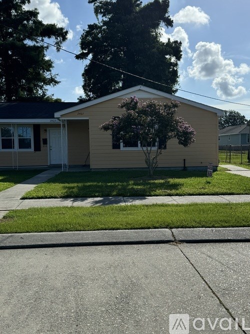 A house with a tree in front of it.