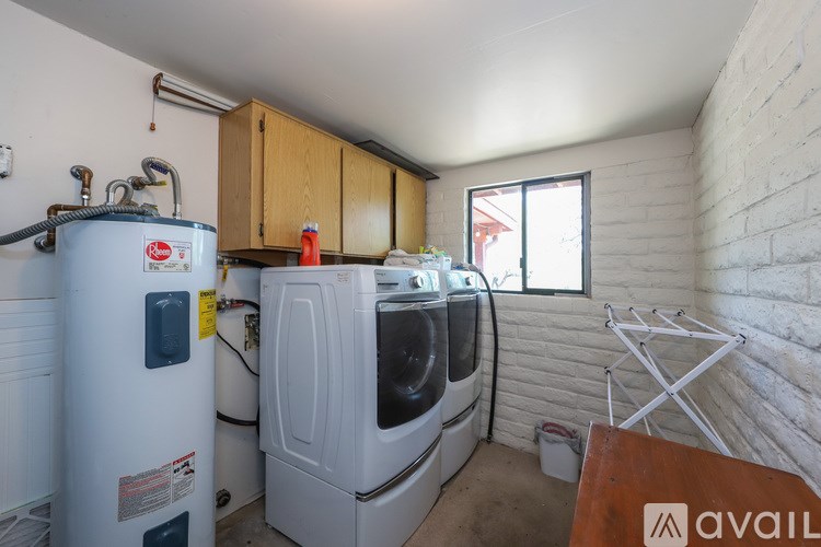 A small laundry room with a washer and dryer.