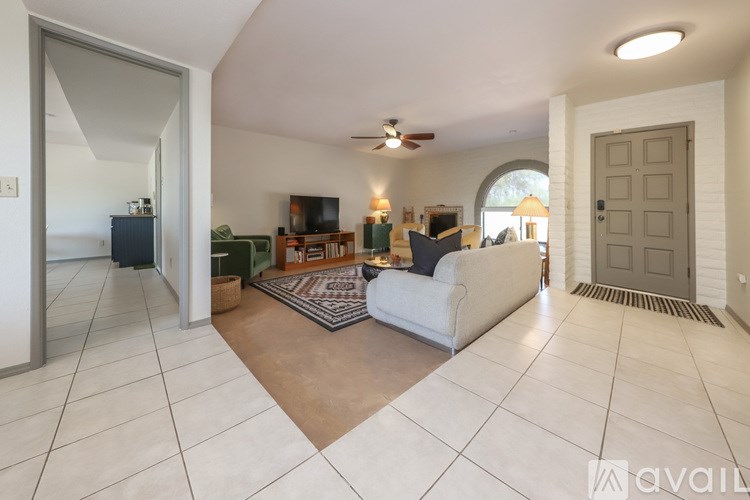 A living room with a white couch and a television.