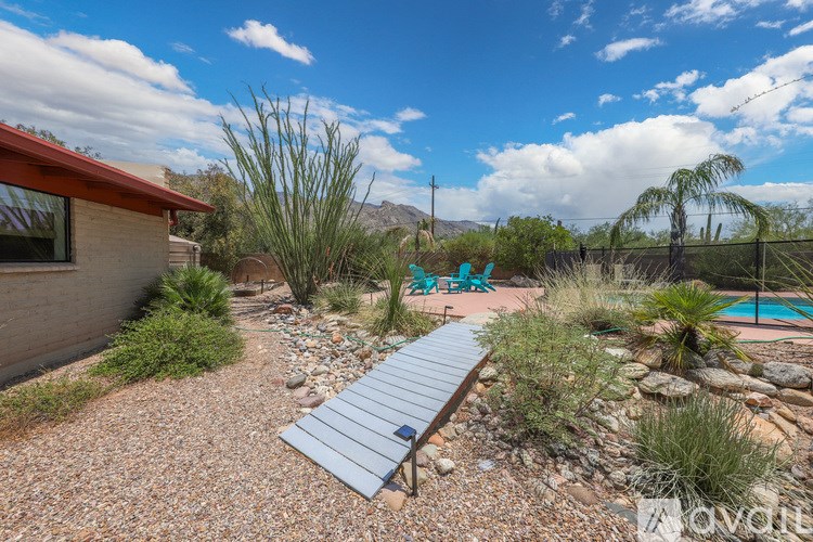 A backyard with a pool and a slide.