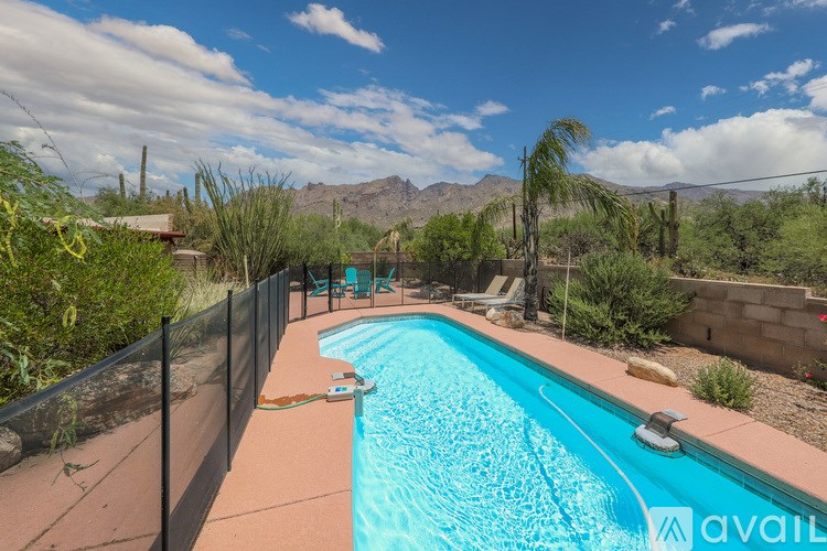A pool surrounded by a black fence with the word "available" written on it.
