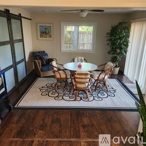 A dining room with a round table and chairs.