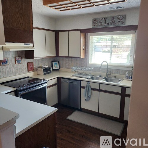 A kitchen with a sign that says "RELAX" on the wall.