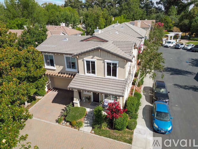 A house with a blue car parked in front.
