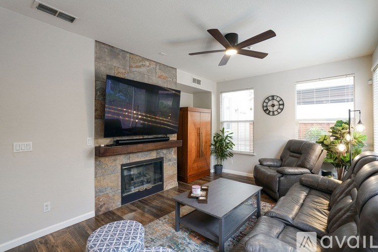 A living room with a fireplace and a television.
