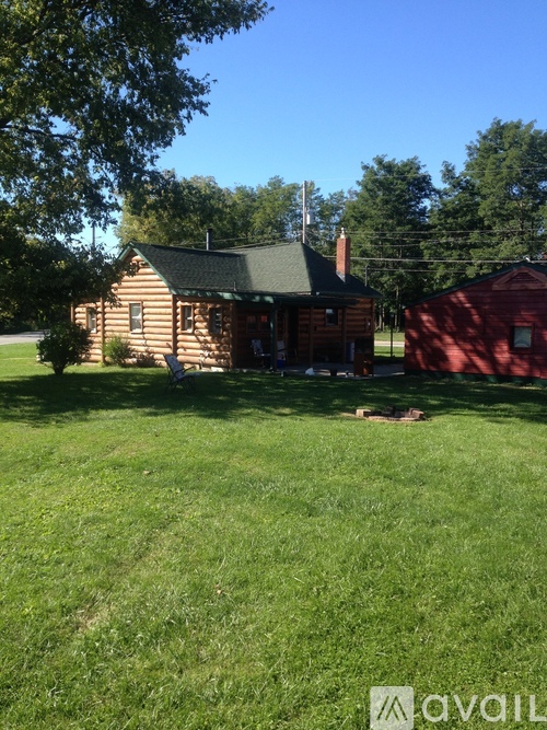 A house with a red shed in the backyard.