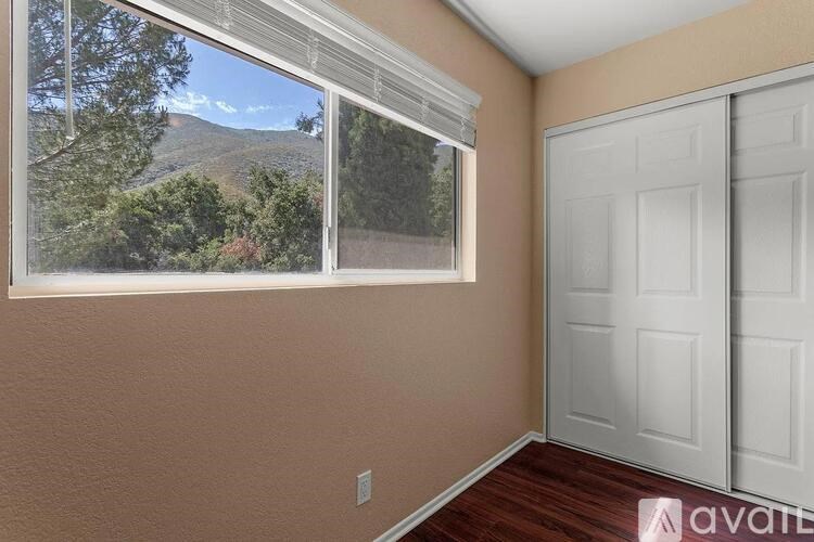 A room with a window and a door.