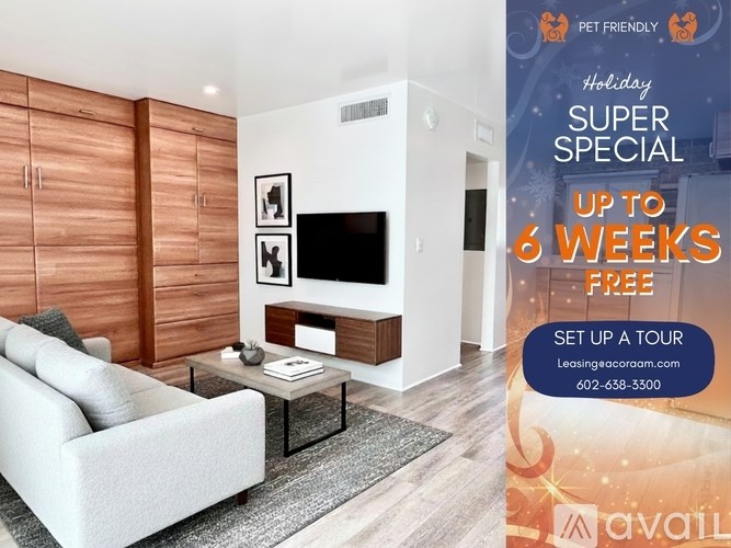 A living room with a sofa, coffee table, and a TV on the wall.