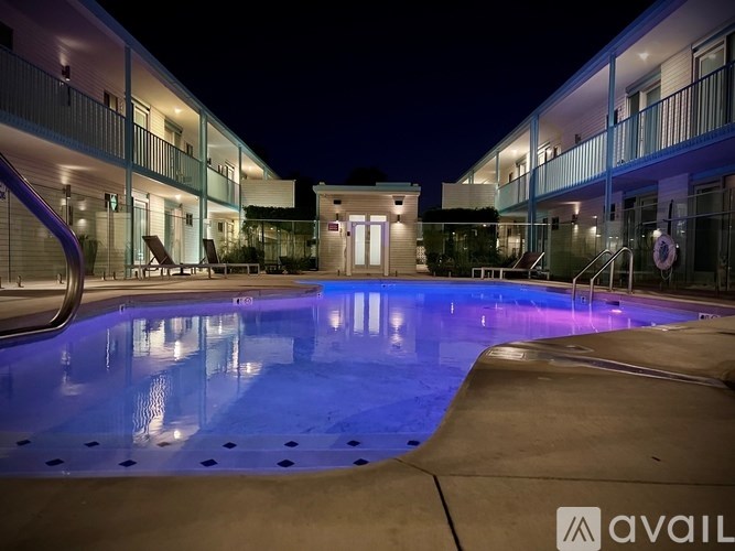 A swimming pool at night with lights reflecting on the water.