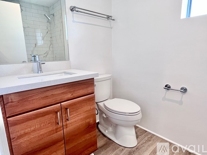 A white toilet sits next to a sink in a bathroom.