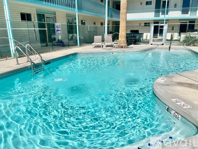 A swimming pool with a slide and a person swimming.