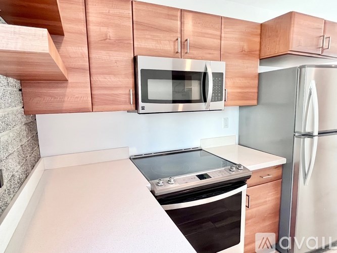 A kitchen with a stove top oven and a microwave above it.