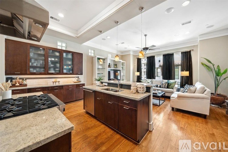 A modern kitchen with dark wood cabinets and a granite countertop.