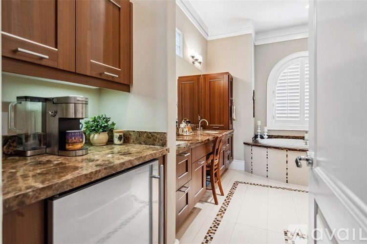 A kitchen with brown cabinets and a white dishwasher.