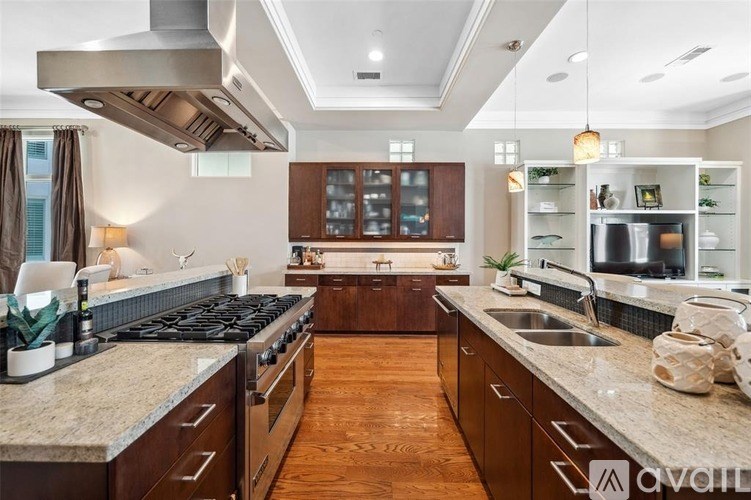 A modern kitchen with a large island and stainless steel appliances.