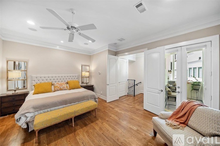 A bedroom with a large bed and a couch.