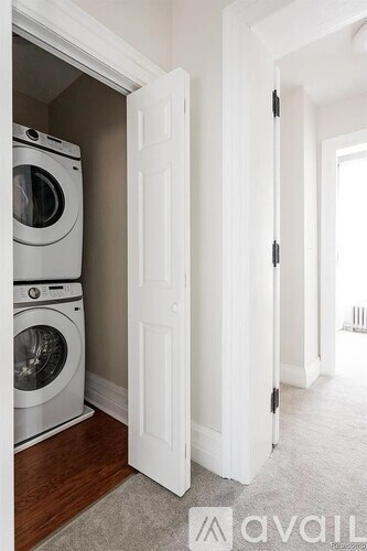 A white door is open to a laundry room.