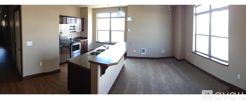 A kitchen with a refrigerator, sink, and a window.