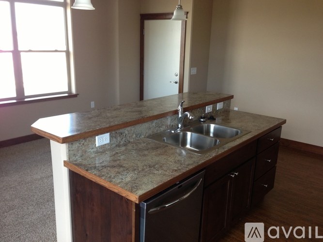 A kitchen with granite countertops and stainless steel appliances.