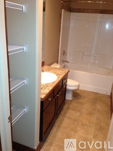 A bathroom with a toilet, sink, and walk-in shower.