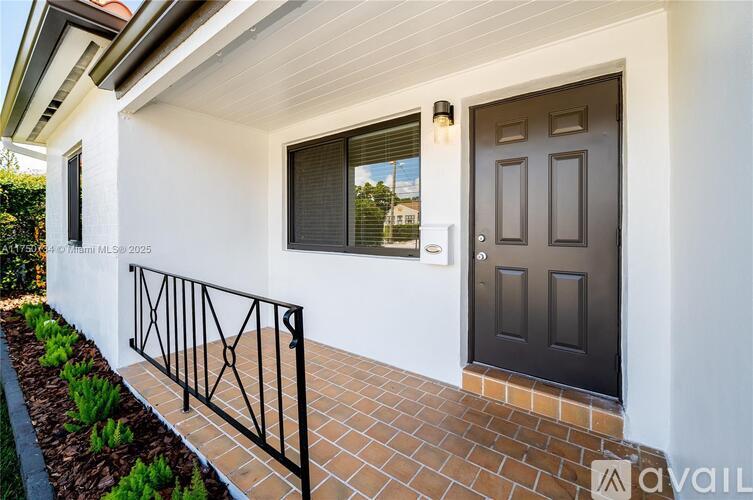 A white house with a black door and window.