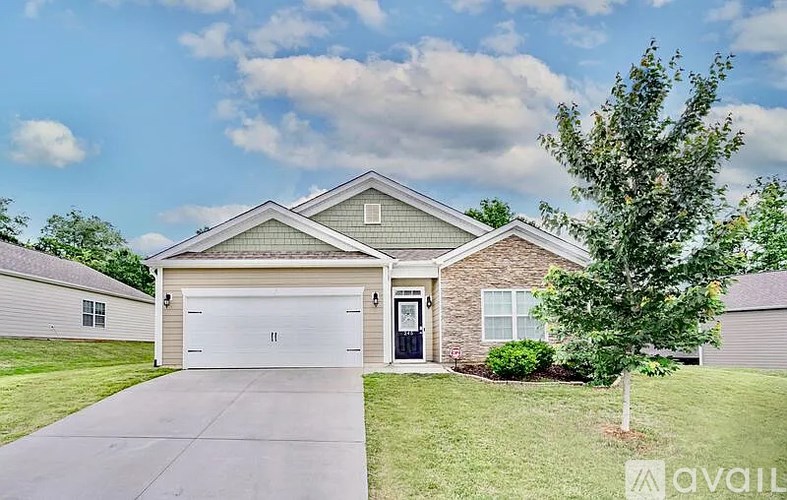 A house with a garage and a driveway in front.