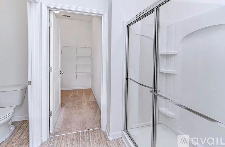 A bathroom with a toilet and a walk-in closet.
