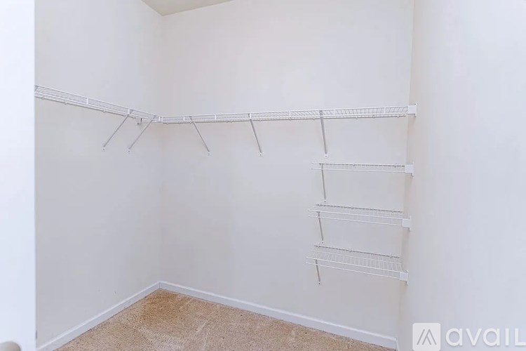 Empty white room with shelving unit.