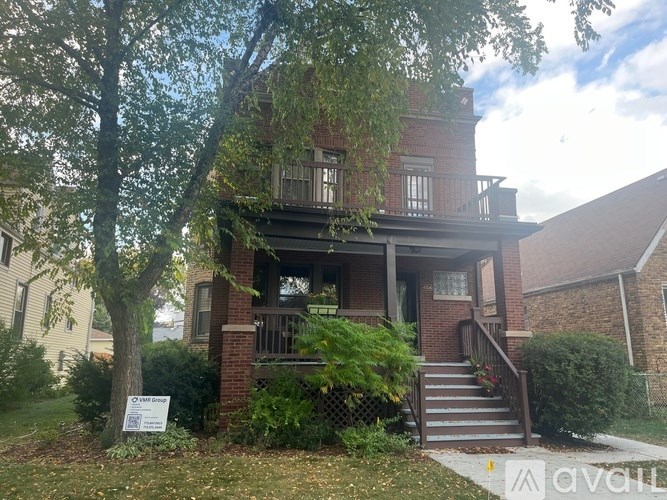 A house with a sign in front of it that says "For Sale".