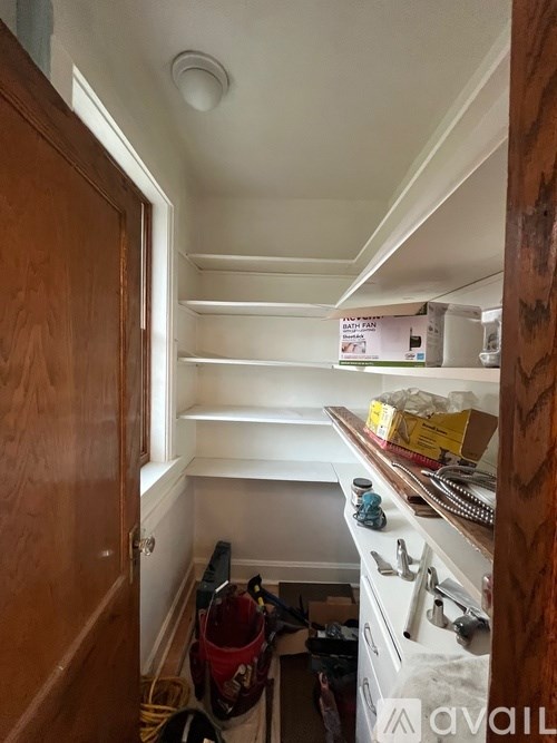 A small room with a wooden door and a white ceiling.