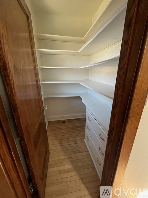 A wooden hallway with drawers and shelves.