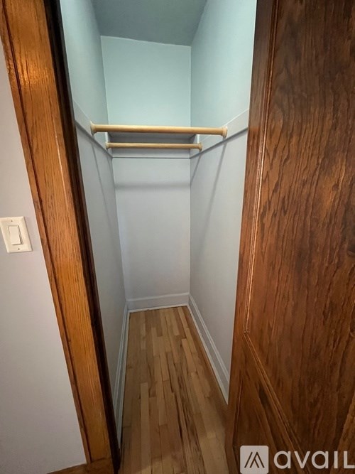 A small closet with a shelf and a light switch.