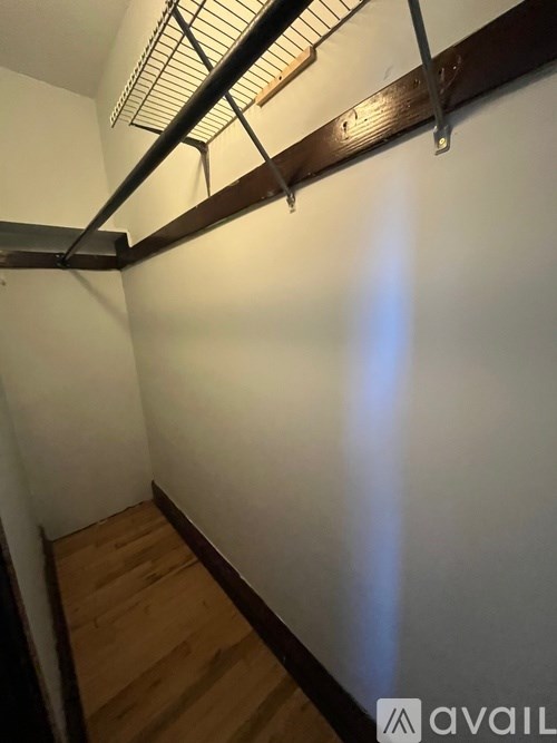 A long hallway with a light on the wall.