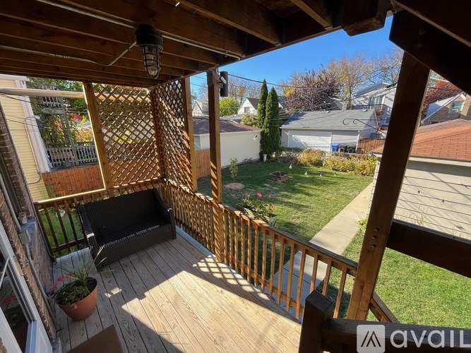 A wooden deck with a lattice screen and a potted plant.