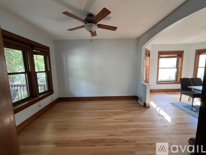 A room with wooden floors and a ceiling fan.