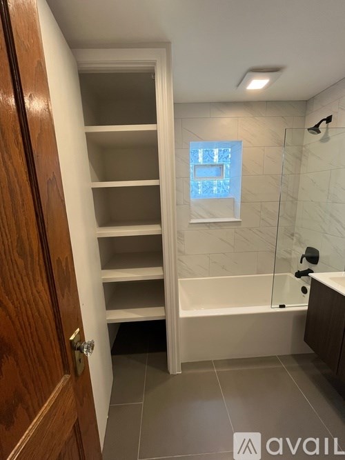 A room with wooden floors and a ceiling fan.