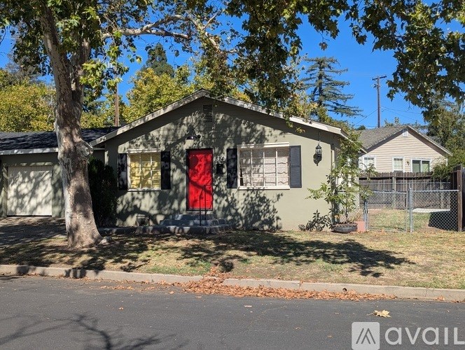 A house with a red door is for sale.