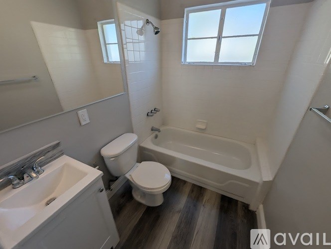 A bathroom with a toilet, sink, and bathtub.