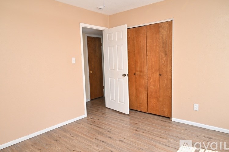 A room with a white door and a brown door.